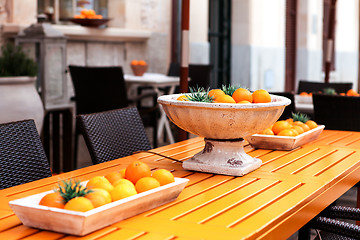 Image showing fresh orange fruits decorative on table in summer