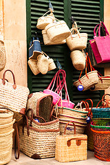 Image showing handmade colorful straw handbags on market sale summer