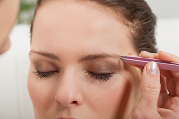 Image showing young beautiful woman eyebrow plucking tweezers eyes hair 