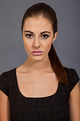 Image showing young brunette woman with brown dress and yellow tights