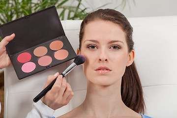 Image showing apllying powder rouge make up on face portrait