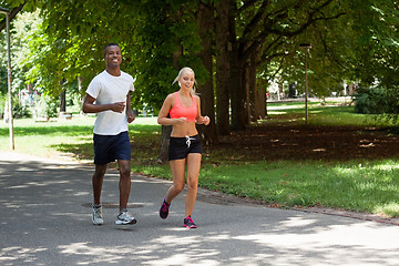 Image showing young couple runner jogger in park outdoor summer