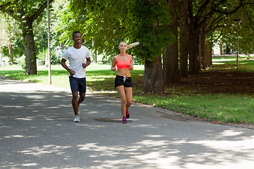 Image showing young couple runner jogger in park outdoor summer