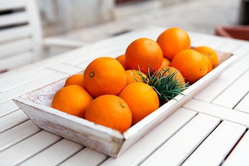 Image showing fresh orange fruits decorative on table in summer