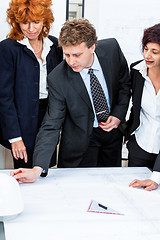 Image showing business people discussing architecture plan sketch 