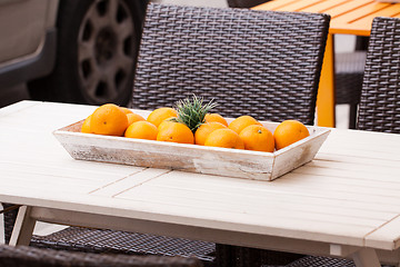 Image showing fresh orange fruits decorative on table in summer