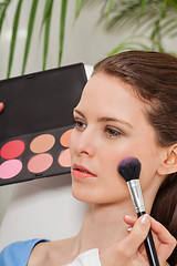 Image showing apllying powder rouge make up on face portrait