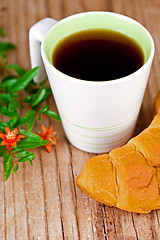 Image showing cup of tea and fresh croissant 