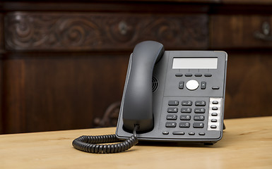 Image showing phone on wooden table in living room