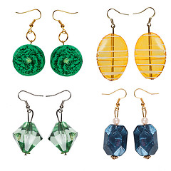 Image showing Earrings made of plastic and glass on a white background. Collag