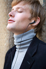 Image showing listening to music with earphones