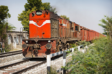 Image showing Old locomotive pulling freight train
