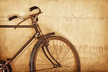 Image showing Old-fashioned rusty bicycle near the wall