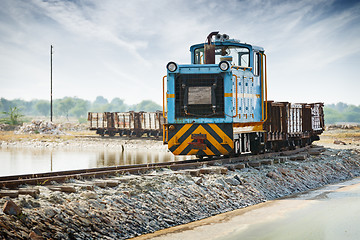 Image showing Old small blue locomotive and freight train