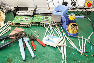 Image showing electronics equipment assembly workplace