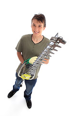 Image showing Smiling young male with garden tool