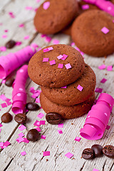 Image showing fresh chocolate cookies, coffee beans, pink ribbons and confetti