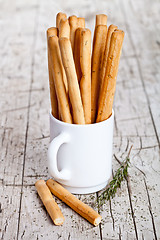 Image showing cup with bread sticks grissini and rosemary