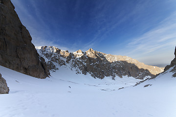 Image showing Two hikers on snowy mountains in morning