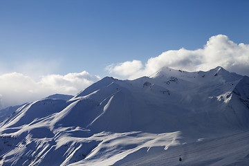 Image showing View on ski slope and sunlight mountains in evening