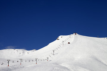 Image showing Ski slope with ropeway at sun winter day