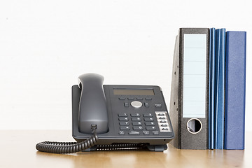 Image showing modern business phone with ring binder