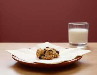 Image showing Oatmeal raisin cookie with a glass of milk 