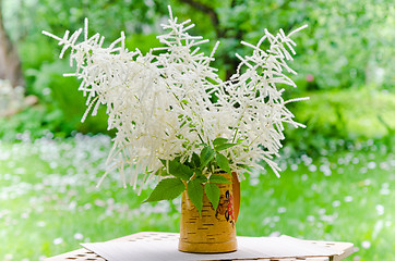 Image showing Bouquet of wild flowers in a pot at the table  