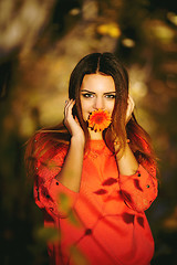 Image showing Girl with a flower in his mouth