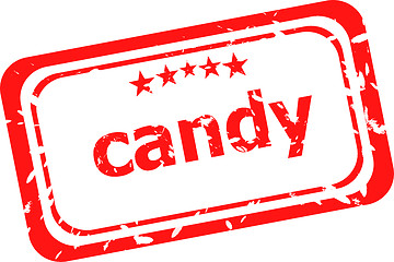 Image showing candy on red rubber stamp over a white background