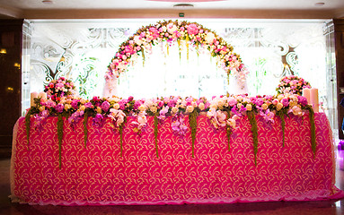 Image showing Floral arch and a table