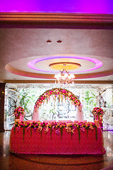 Image showing Floral arch and a table