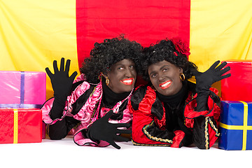 Image showing Two Zwarte Pieten lying