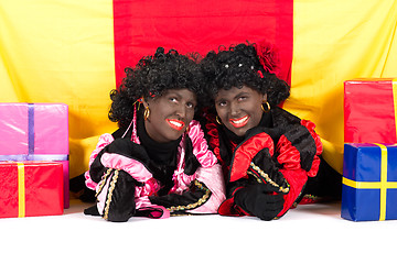 Image showing Two Zwarte Pieten lying