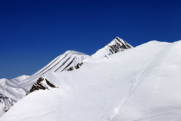 Image showing Off-piste slope with traces of skis in nice day