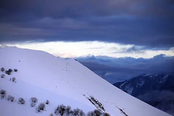 Image showing Off-piste slope and cloudy sky at sunset