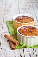 Image showing two fresh baked buns and cinnamon sticks