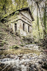 Image showing Creek in forest with old house