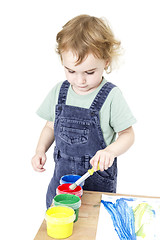 Image showing child with brush and paint in white background