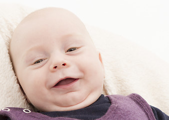 Image showing newborn child laughing to camera