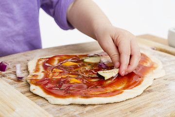 Image showing hand of cld making fresh pizza