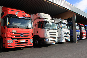 Image showing Mercedes-Benz and Scania Trucks in a Carport