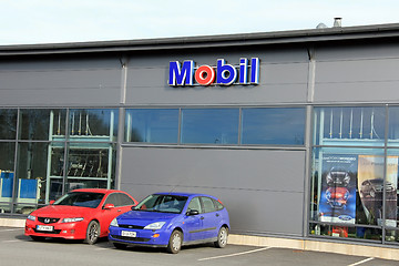 Image showing Sign Mobil on a Shop Wall with Red and Blue Cars