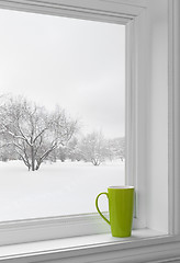 Image showing Green cup on a windowsill