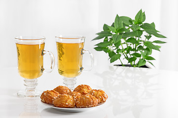 Image showing Tea in glass cups and tasty cookies