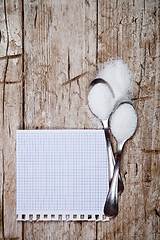 Image showing sugar in two spoons and piece of paper 