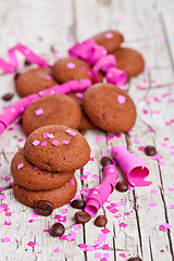 Image showing fresh chocolate cookies, coffee beans, pink ribbons and confetti