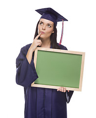 Image showing Thinking Female Graduate in Cap and Gown Holding Blank Chalkboar