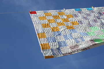 Image showing Laundry - bright counterpane hanging to dry