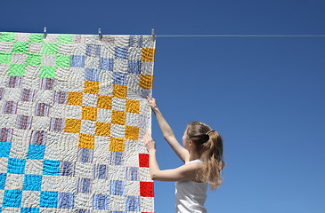 Image showing Girl and bright laundry